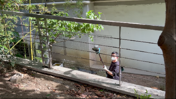 Jovant cordless pole angle grinder for DIY metal renovation on outdoor fencegrinder
