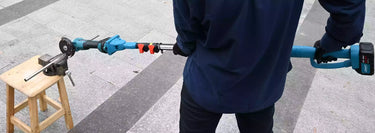 A man using an extended reach angle grinder to cut metal at a distance.